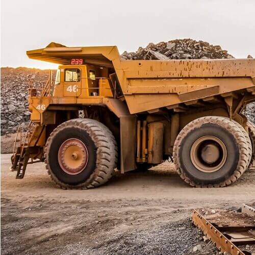 Heavy trucks at an open-pit mining operation