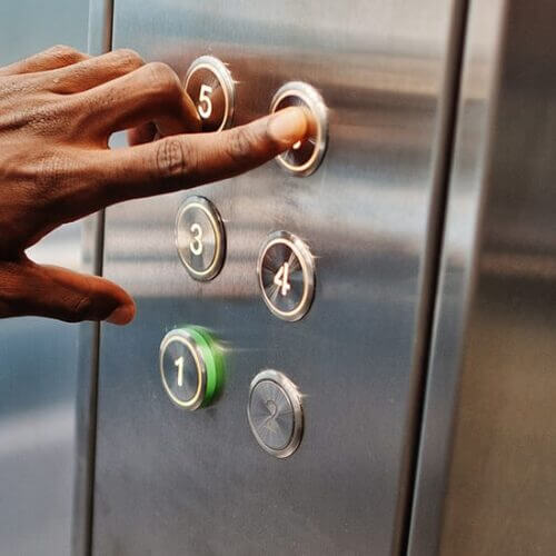 Man presses an elevator button