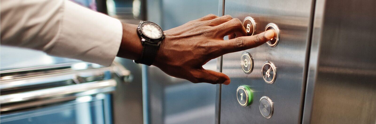 Man presses an elevator button