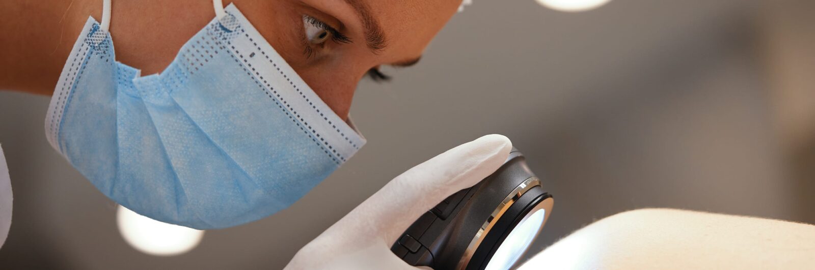 A dermatologist examines a patient's skin