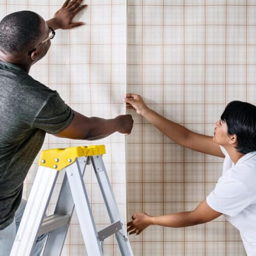 A couple hang new wallpaper