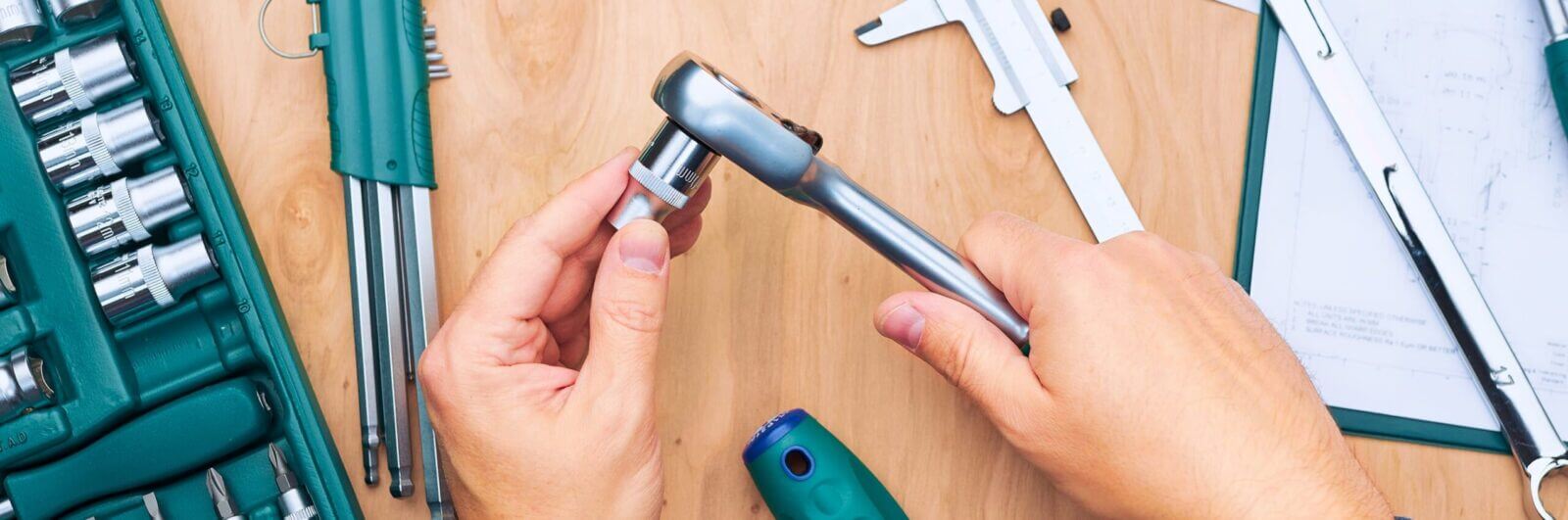 Hands holding hand tools