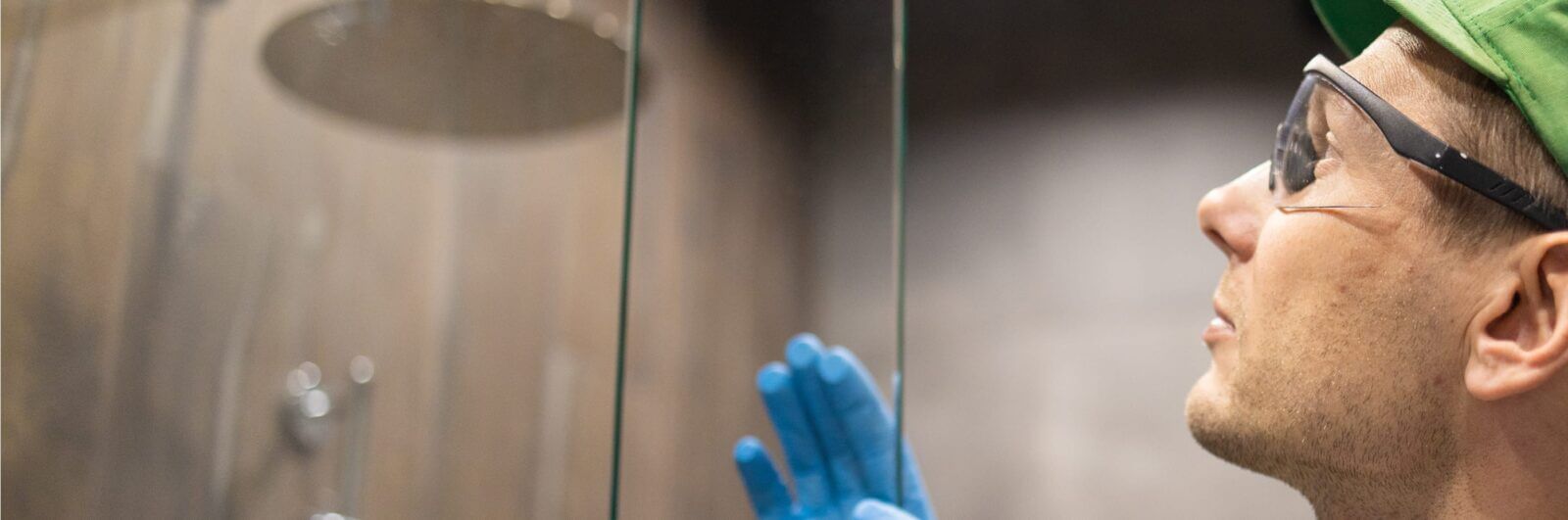 Worker installing a glass shower door