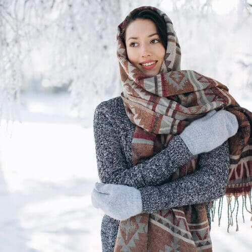 A woman bundled up in a winter landscape