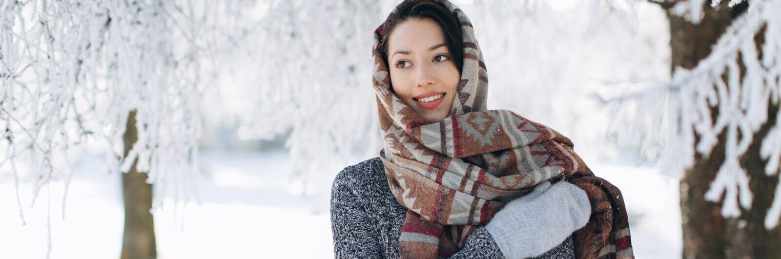A woman bundled up in a winter landscape