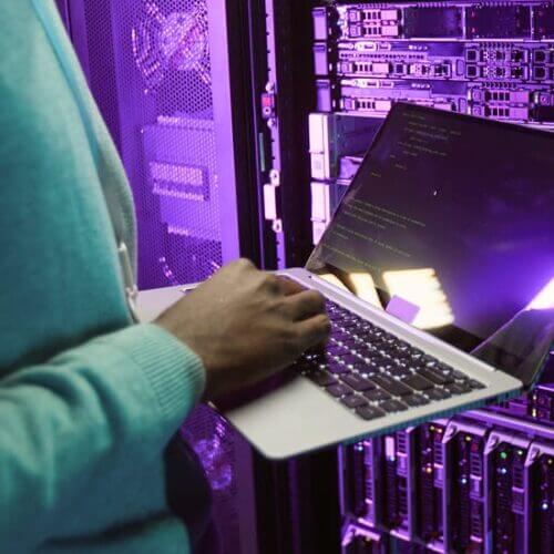 I.T. tech checking data points in a server room